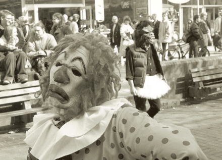 Pete Brown in clown mask performing poetry in Southampton City Centre on Ledbury Portal